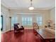 Bright living room with hardwood floors, bay window, comfortable seating, and natural light at 335 Woodridge Dr, Geneva, FL 32732