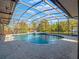 Inviting kidney-shaped pool with a screened enclosure at 335 Woodridge Dr, Geneva, FL 32732