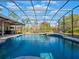 Large screened pool with a spa and open space at 335 Woodridge Dr, Geneva, FL 32732