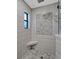 Large walk-in shower with hexagonal tile and bench at 335 Woodridge Dr, Geneva, FL 32732