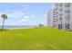 Oceanfront property with lush green lawn and building exterior at 5203 S Atlantic Ave # 814B, New Smyrna Beach, FL 32169