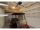 Garage with golf cart and ample storage shelving at 915 Maple St, New Smyrna Beach, FL 32169