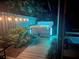 Night view of hot tub with surrounding lights and plants at 915 Maple St, New Smyrna Beach, FL 32169