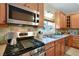 Close-up of kitchen featuring stainless steel appliances and wood cabinetry at 915 Maple St, New Smyrna Beach, FL 32169