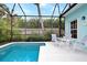 Screened pool and patio furniture under a covered area at 915 Maple St, New Smyrna Beach, FL 32169