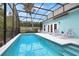 Relaxing screened pool area with lounge chairs and a view at 915 Maple St, New Smyrna Beach, FL 32169