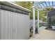 Metal storage shed with a pergola and lush landscaping at 915 Maple St, New Smyrna Beach, FL 32169