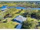 Aerial view of a home on a waterfront lot with lush greenery at 977 Bay Dr, New Smyrna Beach, FL 32168