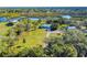 Aerial view of home on waterfront property with lush landscaping at 977 Bay Dr, New Smyrna Beach, FL 32168