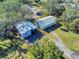 Property with detached garage, workshop, and mature trees at 977 Bay Dr, New Smyrna Beach, FL 32168