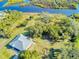 Aerial view of a house near the water, showcasing waterfront property at 977 Bay Dr, New Smyrna Beach, FL 32168