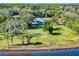 Aerial view of waterfront home with a large backyard and dock at 977 Bay Dr, New Smyrna Beach, FL 32168