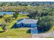 Aerial view of home on waterfront property with lush landscaping at 977 Bay Dr, New Smyrna Beach, FL 32168