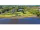 Waterfront home nestled on a spacious lot with mature trees at 977 Bay Dr, New Smyrna Beach, FL 32168