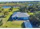 Aerial view of home on waterfront property with lush landscaping at 977 Bay Dr, New Smyrna Beach, FL 32168