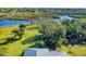 Aerial view showcasing a home, expansive lawn, and waterfront access at 977 Bay Dr, New Smyrna Beach, FL 32168