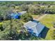 Aerial view of a home with metal roof, detached garages, and expansive land at 977 Bay Dr, New Smyrna Beach, FL 32168