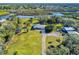 Aerial view of waterfront property with home and outbuildings at 977 Bay Dr, New Smyrna Beach, FL 32168