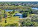 Aerial view of home on waterfront property with lush landscaping at 977 Bay Dr, New Smyrna Beach, FL 32168