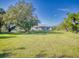 Spacious backyard with large oak trees and grassy lawn at 977 Bay Dr, New Smyrna Beach, FL 32168