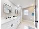 Modern bathroom with double vanity, large mirrors, and a walk-in shower at 977 Bay Dr, New Smyrna Beach, FL 32168