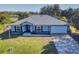 House exterior view, featuring a metal roof and landscaping at 977 Bay Dr, New Smyrna Beach, FL 32168