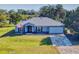 Single-story home with metal roof, attached garage, and a spacious lawn at 977 Bay Dr, New Smyrna Beach, FL 32168