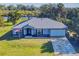 Single-story home with metal roof, attached garage, and a spacious lawn at 977 Bay Dr, New Smyrna Beach, FL 32168