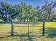 Black metal gate with wire fence at 977 Bay Dr, New Smyrna Beach, FL 32168