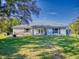 House back exterior with patio and fire pit area at 977 Bay Dr, New Smyrna Beach, FL 32168