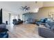 Relaxing living room with multiple leather recliners and wood-look floors at 977 Bay Dr, New Smyrna Beach, FL 32168