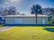 Detached workshop with a large roll-up door at 977 Bay Dr, New Smyrna Beach, FL 32168