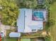 An aerial view of a house featuring a screen-enclosed pool at 1052 Tompkins Dr, Port Orange, FL 32129