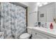 Bathroom featuring a shower with patterned curtain, white vanity, and modern fixtures at 1052 Tompkins Dr, Port Orange, FL 32129