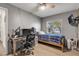 Bedroom showcasing a bed, desk, modern chair, and a window providing natural light at 1052 Tompkins Dr, Port Orange, FL 32129