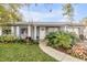 Charming home featuring a well-manicured lawn, front garden, and welcoming entryway at 1052 Tompkins Dr, Port Orange, FL 32129