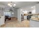 Inviting kitchen and living area featuring white cabinets, stainless appliances and a cozy seating area at 1052 Tompkins Dr, Port Orange, FL 32129