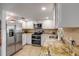 Bright kitchen features stainless steel appliances, granite countertops, and white cabinetry at 1052 Tompkins Dr, Port Orange, FL 32129