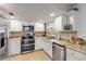 Modern kitchen with stainless steel appliances, granite countertops, and ample cabinet space at 1052 Tompkins Dr, Port Orange, FL 32129