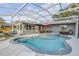 A backyard featuring an in-ground pool, hot tub and an outdoor seating area under a screened enclosure at 1052 Tompkins Dr, Port Orange, FL 32129
