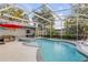 An inviting screened-in pool with adjacent hot tub and patio seating area at 1052 Tompkins Dr, Port Orange, FL 32129