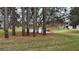 Scenic community lake view with lush green lawn and mature trees adding to the natural beauty of the surroundings at 112 Reserve Cir # 104, Oviedo, FL 32765