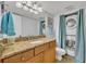 Bathroom with granite vanity, stackable washer/dryer, and tiled floor at 116 Cedar Dunes Dr, New Smyrna Beach, FL 32169