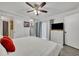 Bright bedroom featuring a comfy bed and large TV at 116 Cedar Dunes Dr, New Smyrna Beach, FL 32169
