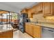 Cozy kitchen featuring granite countertops, stainless steel appliances and access to the screened in patio at 116 Cedar Dunes Dr, New Smyrna Beach, FL 32169