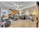 Cozy living room with rustic wood paneling, comfortable seating, and a ceiling fan at 116 Cedar Dunes Dr, New Smyrna Beach, FL 32169