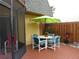 Small patio with table, chairs, and umbrella at 116 Cedar Dunes Dr, New Smyrna Beach, FL 32169
