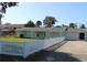 Light green ranch house with white picket fence and attached garage at 1908 S Riverside Dr, Edgewater, FL 32141