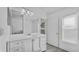 Bathroom features a white vanity, large mirror and gray floor at 230 Oak Branch Dr, Edgewater, FL 32141