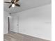 Well-lit bedroom with ceiling fan and door at 230 Oak Branch Dr, Edgewater, FL 32141